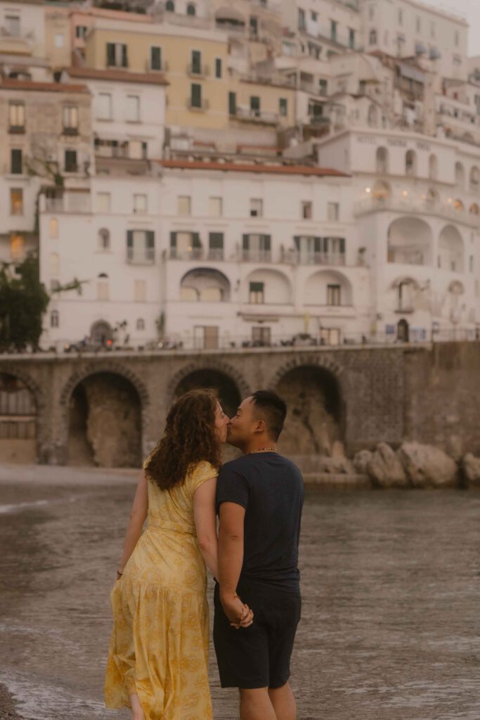 Beautiful aesthetic couple and wedding photo on the beach at the Amalfi Coast with professional photographer.